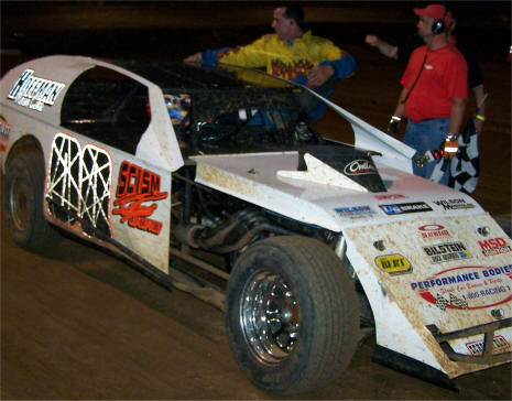 Jesse Stovall climbs out of his Modified after winning Friday night's main event. (Rikki Kelley Photo)