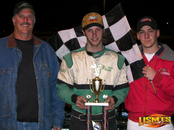 Ryan Ruter in victory lane with his father (left) and flagman Brad Ratcliff.